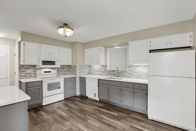384 Sandburr Dr, Columbus, OH 43230 - kitchen featuring white appliances, gray cabinetry, backsplash, light countertops, and white cabinets