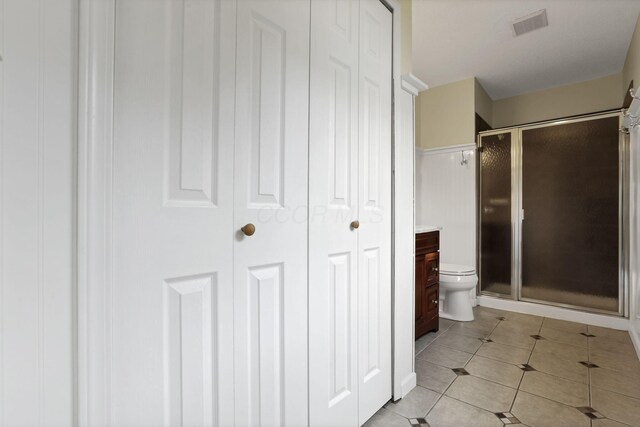 384 Sandburr Dr, Columbus, OH 43230 - full bathroom featuring a closet, a stall shower, and tile patterned flooring