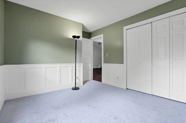 384 Sandburr Dr, Columbus, OH 43230 - unfurnished bedroom with carpet flooring, wainscoting, a decorative wall, and a closet
