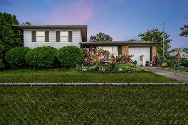 1567 Venice Dr, Columbus, OH 43207 - split level home featuring concrete driveway, an attached garage, and brick siding