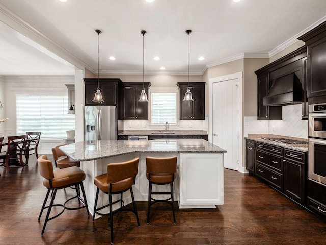 2462 Mccumber Ln, Lewis Center, OH 43035 - kitchen with stainless steel appliances, a center island, a sink, custom range hood, and decorative backsplash