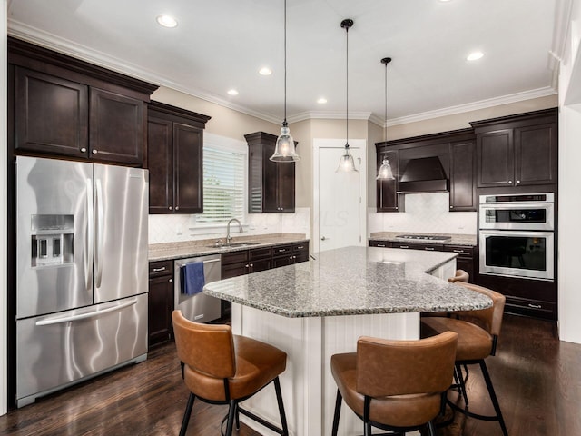2462 Mccumber Ln, Lewis Center, OH 43035 - kitchen with appliances with stainless steel finishes, a sink, premium range hood, a kitchen island, and dark brown cabinetry