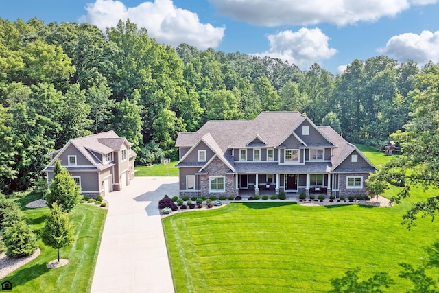 9568 Craigens Ct, Galena, OH 43021 - craftsman-style home featuring driveway, covered porch, a front yard, and stone siding