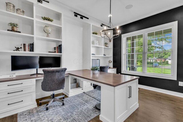 9568 Craigens Ct, Galena, OH 43021 - office area with a chandelier, ornamental molding, dark wood finished floors, built in desk, and baseboards