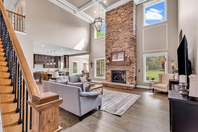 9568 Craigens Ct, Galena, OH 43021 - living area with a high ceiling, stairs, plenty of natural light, a chandelier, and wood-type flooring
