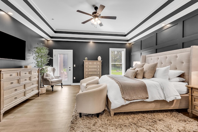 9568 Craigens Ct, Galena, OH 43021 - bedroom with a tray ceiling, crown molding, access to outside, light wood-style floors, and ceiling fan
