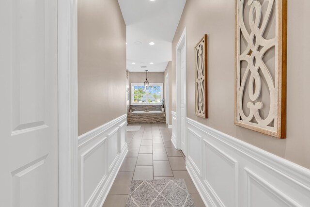 9568 Craigens Ct, Galena, OH 43021 - hallway with wainscoting, dark tile patterned floors, a decorative wall, and recessed lighting