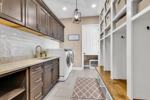 9568 Craigens Ct, Galena, OH 43021 - laundry room with washing machine and clothes dryer, cabinet space, light tile patterned flooring, baseboards, and recessed lighting