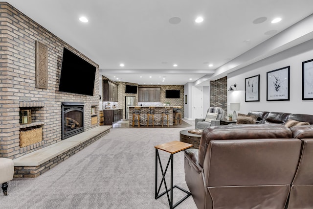 9568 Craigens Ct, Galena, OH 43021 - living room featuring brick wall, light carpet, a fireplace, and recessed lighting