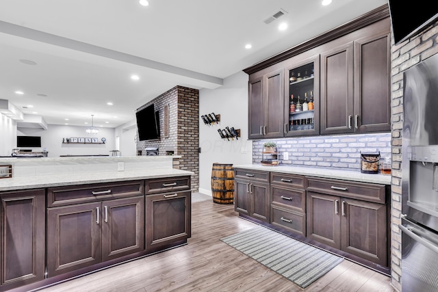 9568 Craigens Ct, Galena, OH 43021 - kitchen with open floor plan, tasteful backsplash, dark brown cabinetry, light wood finished floors, and recessed lighting