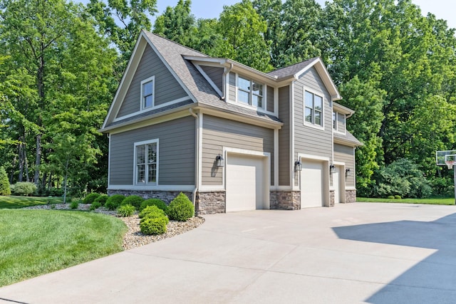 9568 Craigens Ct, Galena, OH 43021 - view of property exterior featuring a garage, concrete driveway, stone siding, and roof with shingles