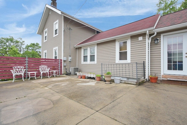 1936 Case Rd, Columbus, OH 43224 - back of house with a chimney and a patio area