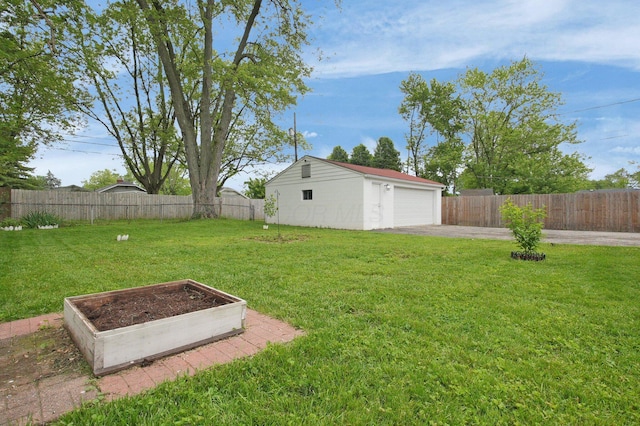 1936 Case Rd, Columbus, OH 43224 - view of yard featuring a vegetable garden, an outbuilding, and a detached garage