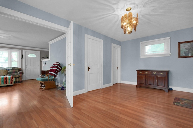 1936 Case Rd, Columbus, OH 43224 - living room featuring light wood finished floors, a chandelier, baseboards, and a ceiling fan