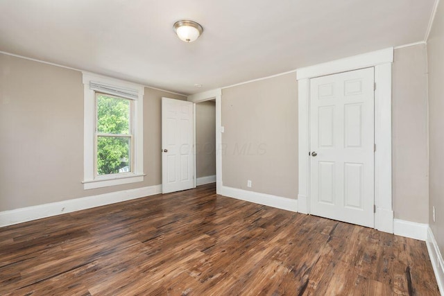 2165 Amherst Ave, Columbus, OH 43223 - unfurnished bedroom with wood finished floors, baseboards, and ornamental molding