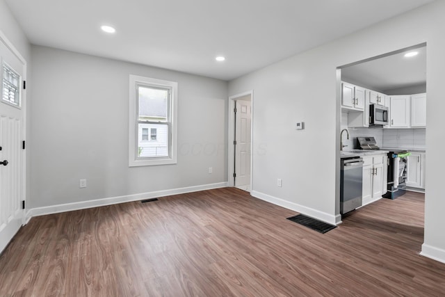 1805 Meriline Ave, Obetz, OH 43207 - kitchen featuring stainless steel appliances, light countertops, healthy amount of natural light, wood finished floors, and recessed lighting
