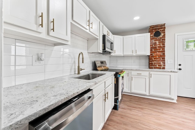 1805 Meriline Ave, Obetz, OH 43207 - kitchen featuring appliances with stainless steel finishes, a sink, white cabinets, decorative backsplash, and recessed lighting