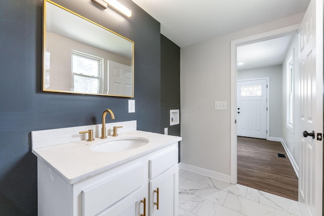1805 Meriline Ave, Obetz, OH 43207 - bathroom with plenty of natural light, vanity, marble look tile flooring, and baseboards