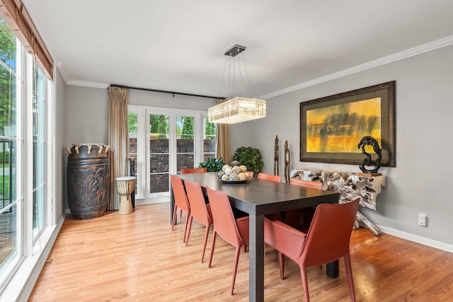 195 S Gould Rd, Columbus, OH 43209 - dining room featuring healthy amount of natural light, light wood-style flooring, ornamental molding, baseboards, and a chandelier