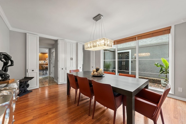 195 S Gould Rd, Columbus, OH 43209 - dining room with wood finished floors, ornamental molding, and a chandelier