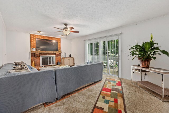 6897 Roundelay Rd N, Reynoldsburg, OH 43068 - carpeted living room with a ceiling fan, a brick fireplace, and a textured ceiling