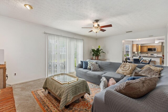 6897 Roundelay Rd N, Reynoldsburg, OH 43068 - living area featuring a ceiling fan, light colored carpet, and a textured ceiling
