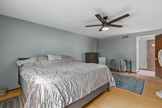 6897 Roundelay Rd N, Reynoldsburg, OH 43068 - bedroom with wood finished floors, a ceiling fan, and baseboards