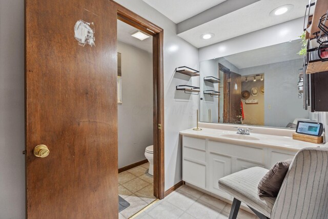 6897 Roundelay Rd N, Reynoldsburg, OH 43068 - bathroom with toilet, vanity, and baseboards