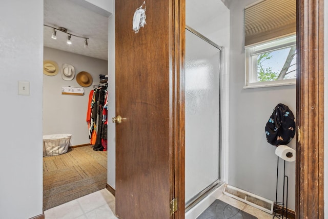 6897 Roundelay Rd N, Reynoldsburg, OH 43068 - full bathroom with a shower stall, a spacious closet, and tile patterned flooring