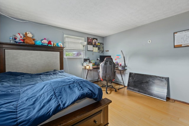 6897 Roundelay Rd N, Reynoldsburg, OH 43068 - bedroom with wood finished floors and a textured ceiling
