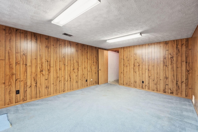 6897 Roundelay Rd N, Reynoldsburg, OH 43068 - finished basement with a textured ceiling, wooden walls, and carpet floors