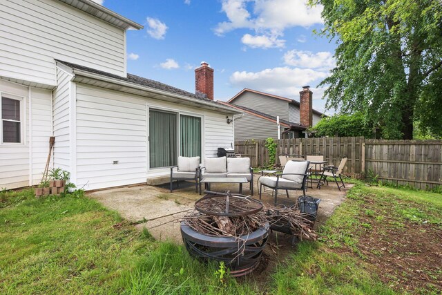 6897 Roundelay Rd N, Reynoldsburg, OH 43068 - rear view of property with a patio and an outdoor living space with a fire pit