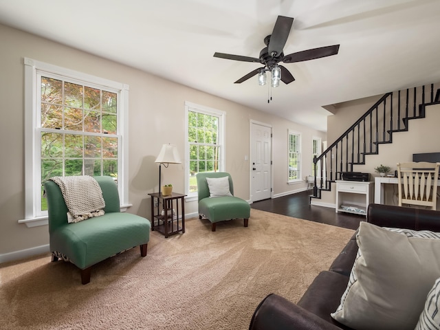 2870 Tarkman Dr, Nashport, OH 43830 - living room featuring stairway, baseboards, a ceiling fan, and dark colored carpet