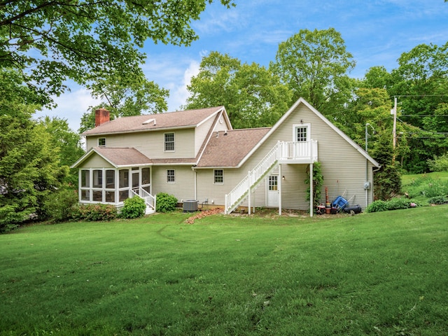 2870 Tarkman Dr, Nashport, OH 43830 - back of house with a sunroom, a chimney, a lawn, roof with shingles, and stairway