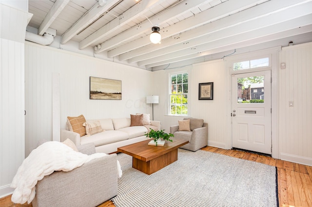 503 City Park Ave, Columbus, OH 43215 - living room featuring light wood finished floors, beamed ceiling, baseboards, and wooden walls