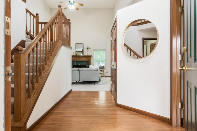 5839 Castleknock Rd, Dublin, OH 43016 - corridor with stairs, baseboards, light wood finished floors, and a high ceiling