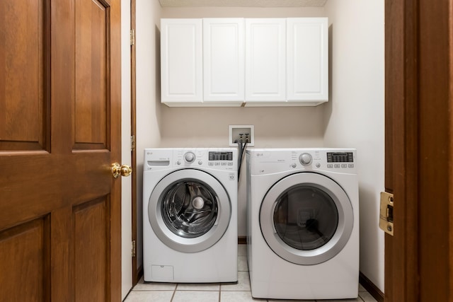 5839 Castleknock Rd, Dublin, OH 43016 - laundry room with cabinet space, washing machine and dryer, and light tile patterned floors