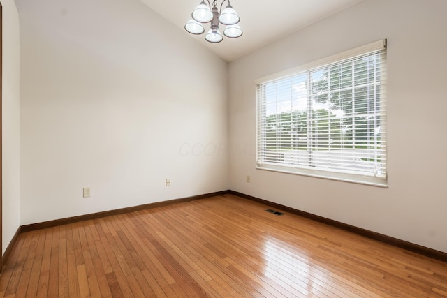 5839 Castleknock Rd, Dublin, OH 43016 - unfurnished room with light wood-style floors, a chandelier, baseboards, and vaulted ceiling