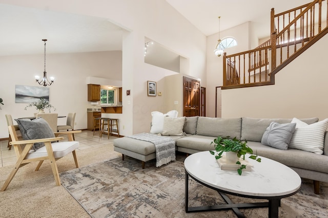 5839 Castleknock Rd, Dublin, OH 43016 - living area featuring a chandelier, high vaulted ceiling, stairway, light colored carpet, and baseboards