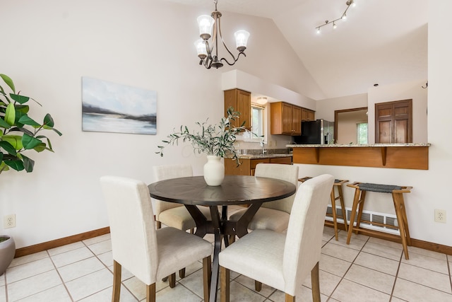 5839 Castleknock Rd, Dublin, OH 43016 - dining area with a chandelier, baseboards, light tile patterned floors, and high vaulted ceiling