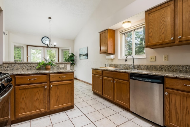 5839 Castleknock Rd, Dublin, OH 43016 - kitchen featuring stainless steel appliances, a sink, brown cabinetry, lofted ceiling, and light tile patterned floors