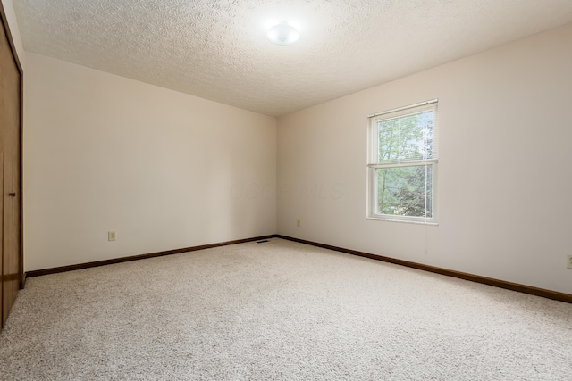 5839 Castleknock Rd, Dublin, OH 43016 - unfurnished room featuring light carpet, a textured ceiling, and baseboards