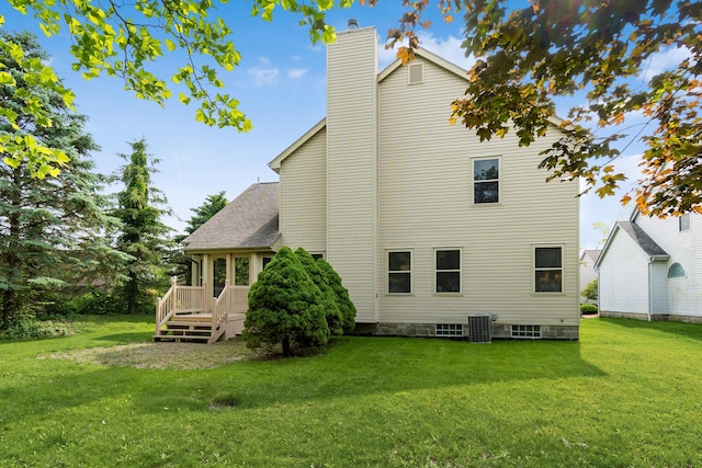 5839 Castleknock Rd, Dublin, OH 43016 - rear view of house with a lawn, a chimney, a deck, and central AC unit
