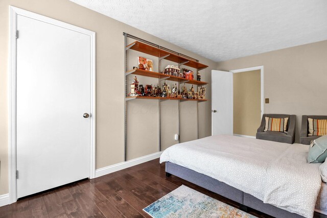 4558 Crompton Dr, Columbus, OH 43220 - bedroom with dark wood-style floors, baseboards, and a textured ceiling
