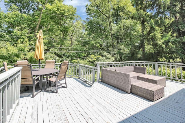 4558 Crompton Dr, Columbus, OH 43220 - wooden deck featuring outdoor dining area, view of wooded area, and outdoor lounge area