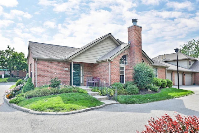 880 Village Brook Way, Columbus, OH 43235 - view of front of home with brick siding, a chimney, and a shingled roof