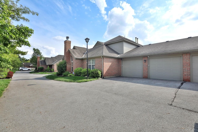 880 Village Brook Way, Columbus, OH 43235 - view of front of home featuring brick siding, a garage, driveway, and a shingled roof