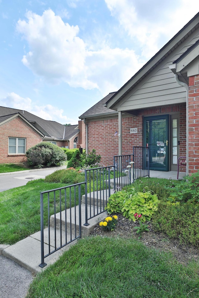 880 Village Brook Way, Columbus, OH 43235 - view of property exterior featuring brick siding, a porch, and a lawn