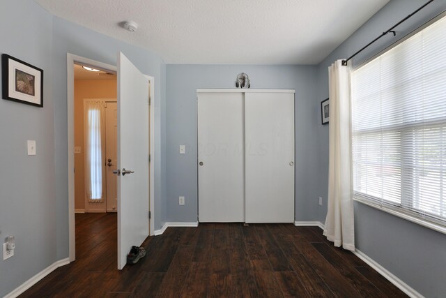 880 Village Brook Way, Columbus, OH 43235 - unfurnished bedroom with wood finished floors, baseboards, and a closet
