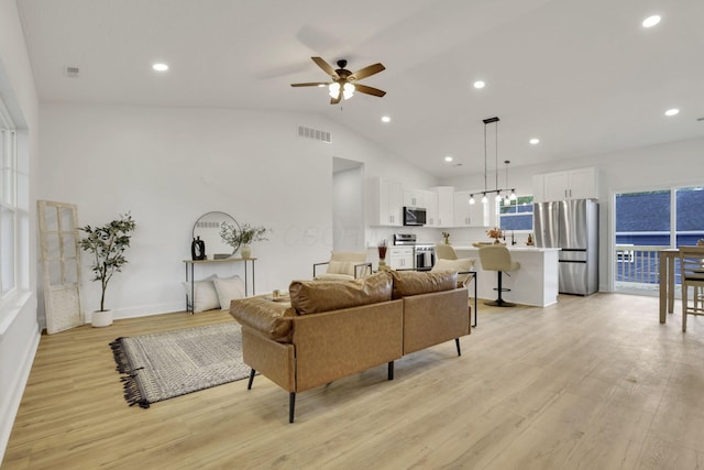 13081 Dogwood Rd NE, Thornville, OH 43076 - living room featuring light wood-style flooring, a ceiling fan, recessed lighting, vaulted ceiling, and baseboards